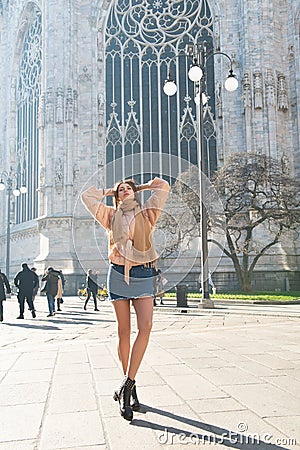 Young attractive woman posing near Milan Cathedral, Italy. Beautiful girl walking Milanese streets Stock Photo