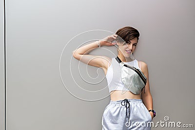 Young attractive woman posing outdoor over silver metal background wall. Beautiful girl. Beautiful caucasian model`s portrait. Stock Photo