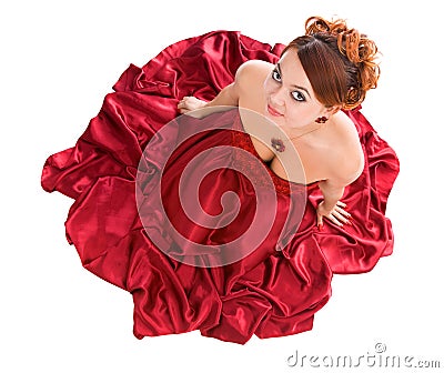 Young attractive woman sitting in red dress Stock Photo