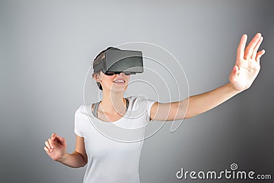 Young attractive woman using a virtual reality headset for first Stock Photo