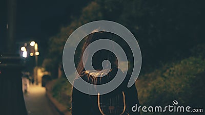 Young attractive woman walking late at night alone in Rome, Italy. Girl goes through the city centre near the Colosseum. Stock Photo