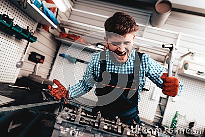 Young Auto Mechanic Is Screaming. Service Station. Stock Photo