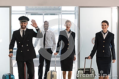 young aviation personnel team with suitcases at airport Stock Photo