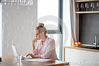 Young awesome female freelancer working on notebook indoors Stock Photo