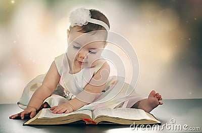 Young baby girl and Bible Stock Photo