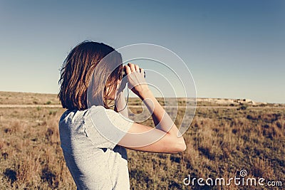 Young Backpack Traveler Using Binoculars Stock Photo