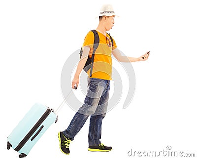 Young backpacker carrying a baggage and holding a smartphone Stock Photo