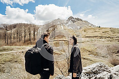 Young backpacker hiker couple enjoying relaxing mountain hike.Active hiking trip vacation.Reconnecting with nature.Climbers Stock Photo
