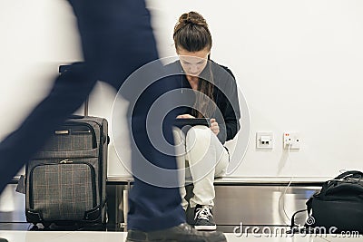 Young backpacker woman waiting for her flight. Stock Photo