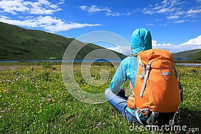 Backpacking woman hiking in mountains Stock Photo