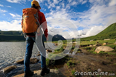 Backpacking woman hiking in mountains Stock Photo