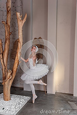 Young ballerina in white tutu with joyful smile fooling around, captures the whimsy of dance Stock Photo