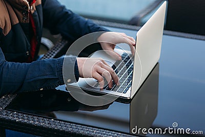 The young bank employee works on a laptop at lunchtime. Stock Photo