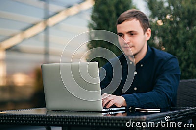 The young bank employee works on a laptop at lunchtime. Stock Photo