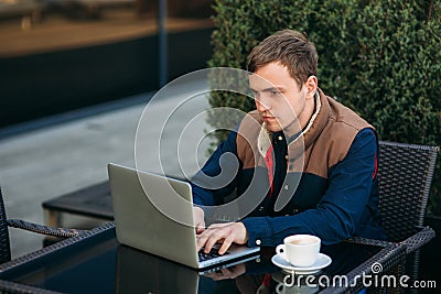 The young bank employee works on a laptop at lunchtime. Stock Photo