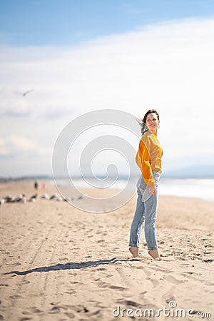 Young barefoot girl on the beach Stock Photo