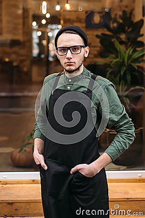 Young barman in black apron Stock Photo