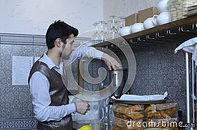 Young barman works with blender at his workplace, Crimean Tartar restaurant Editorial Stock Photo