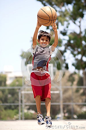 Young basketball player jumping high Stock Photo