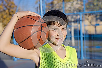 Young basketball player standing on the court wearing a yellow s Stock Photo