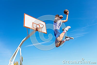 Young Basketball street player making slam dunk Stock Photo