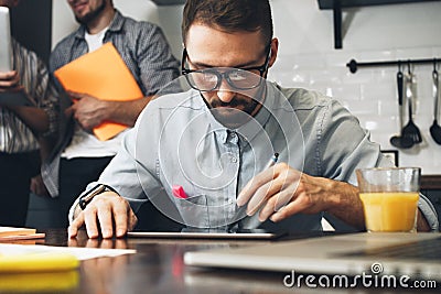 Young bearded business analyst conducts research on a computer t Stock Photo