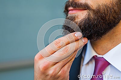 Young bearded businessman thinking abut plans for the weekend. Stock Photo