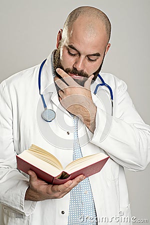 Young bearded doctor with book Stock Photo