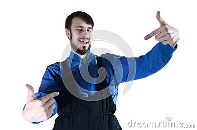 A young bearded guy in working uniform points to himself with his two hands Stock Photo