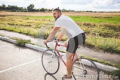 Young bearded hipster driving bicycle Stock Photo