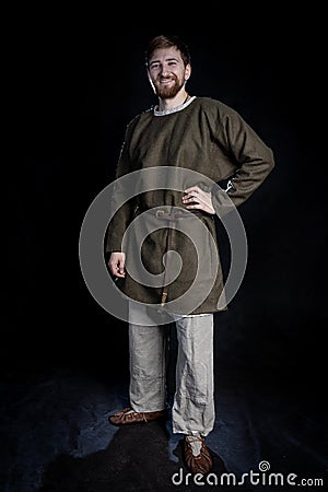 young bearded man in casual wear of a viking era smiling Stock Photo