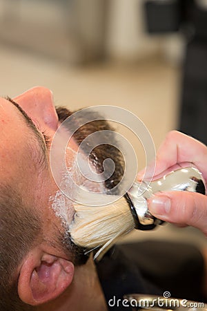 Bearded man getting beard haircut at hairdresser at barbershop Stock Photo