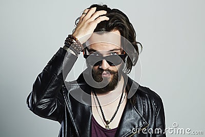 Young bearded man in leather. Hipster in sunglasses Stock Photo