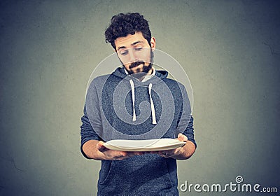 Man with empty plate looking sad Stock Photo