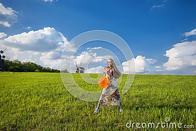 Young beatiful girl in green field Stock Photo