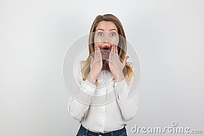 Young beatuiful blond woman standing on isolated white background looks surprised, pure beauty concept Stock Photo