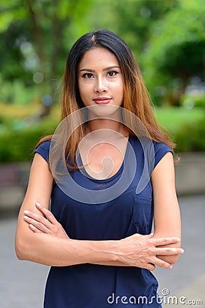 Young beautiful Asian businesswoman in the park Stock Photo