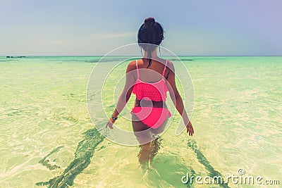 Young beautiful asian girl in bikini enjoy summer holidays on tropical beach. Summer vacation and LifeStyle concept. Stock Photo