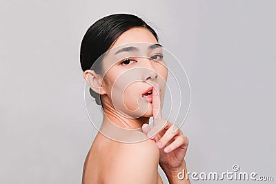 Young beautiful asian woman with clean, fresh and bright skin, Happiness and cheerful with positive emotional,isolated on gray Stock Photo