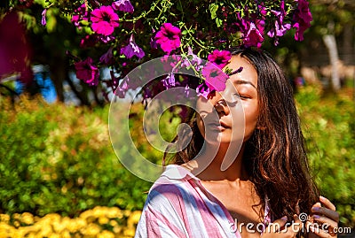 Young asian woman is holding flowers in the garden in the spring. Stock Photo