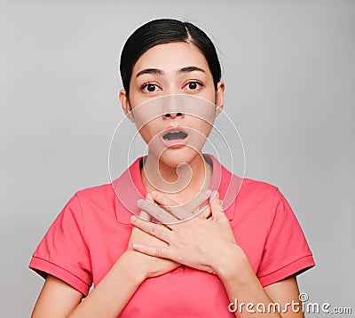 Young beautiful asian woman wore pink t shirt, Showed Shocked expression , on gray background Stock Photo