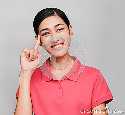 Young beautiful asian woman wore pink t shirt, Showed Thinking expression ,smile on gray background Stock Photo