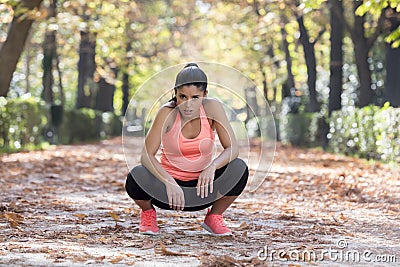 Attractive sport woman in runner sportswear breathing gasping and taking a break tired and exhausted after running workout on Autu Stock Photo