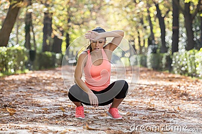 Attractive sport woman in runner sportswear breathing gasping and taking a break tired and exhausted after running workout on Autu Stock Photo