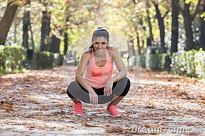 Attractive sport woman in runner sportswear taking a break tired smiling happy and cheerful after running workout Stock Photo
