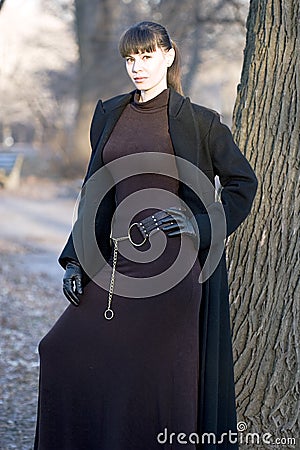 Young beautiful attractive woman in dress and coat Stock Photo