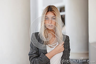 Young beautiful blond girl in vintage gray jacket Stock Photo