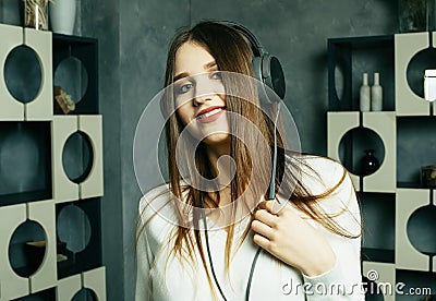 Young beautiful woman in casual outfit enjoying the music at home. Lifestyle, tehnology and people concept. Stock Photo