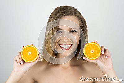 Young beautiful blond woman holding oranges in her hands looking happy isolated white background Stock Photo