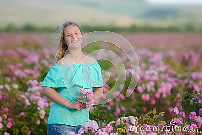 Young beautiful blonde girl on a rose plantation . Stock Photo